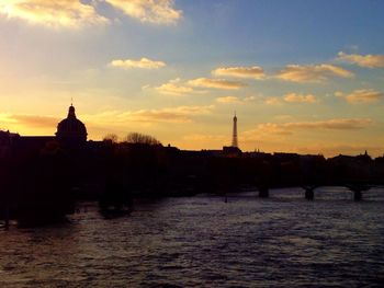 Scenic view of river against sky at sunset