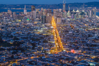 Aerial view of city lit up at night