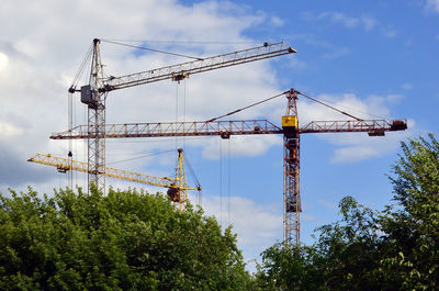 Low angle view of crane against sky