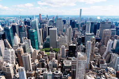 High angle view of modern buildings in city against sky