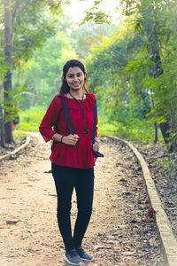 Portrait of young woman walking in forest