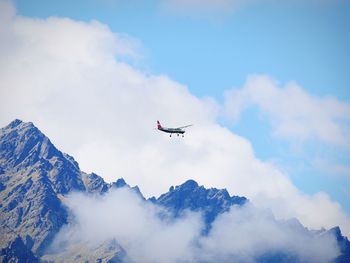 Low angle view of airplane flying in sky