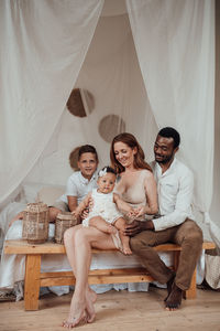 Portrait of young couple sitting at home