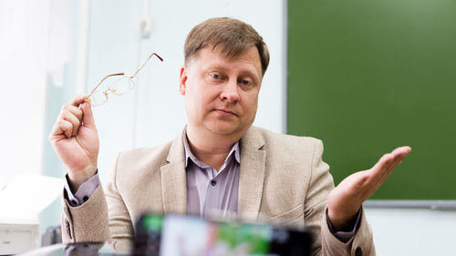 Portrait of young man sitting in office