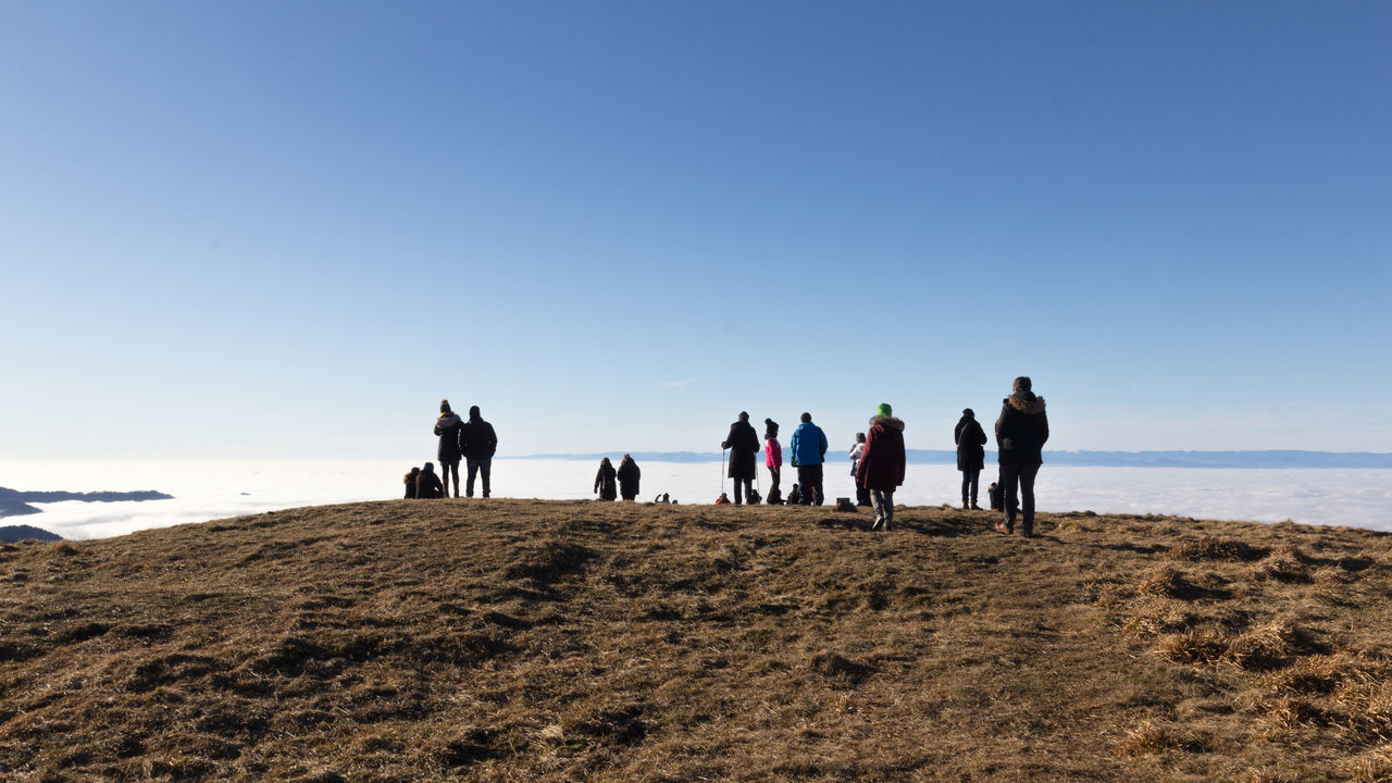 GROUP OF PEOPLE WALKING ON BEACH