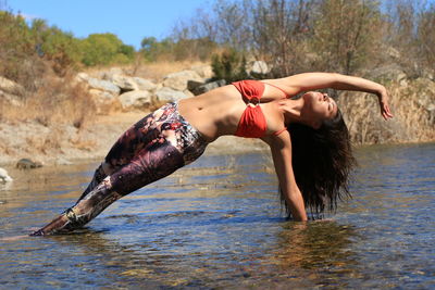 Woman jumping in sea