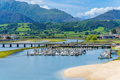 High angle view of sea and mountains against sky