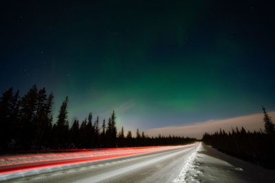 Empty road against sky at night