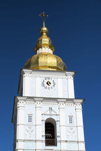 Low angle view of building against clear blue sky