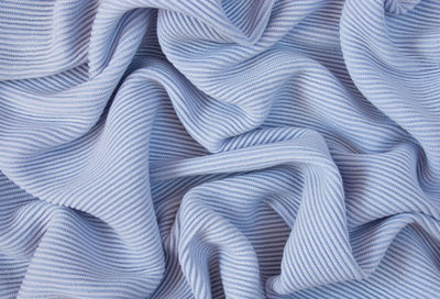 Blue fabric texture. background with folds. close-up.