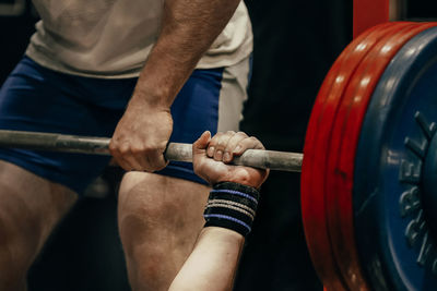 Midsection of man exercising in gym