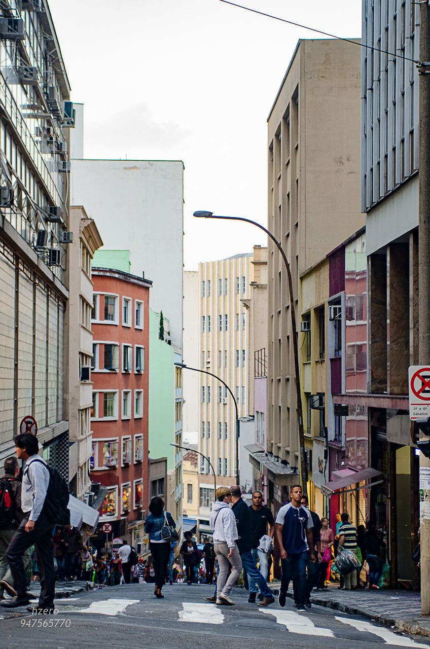 PEOPLE WALKING ON STREET IN CITY