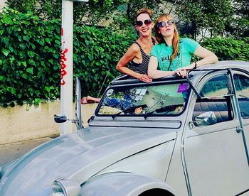 Portrait of smiling young woman in car