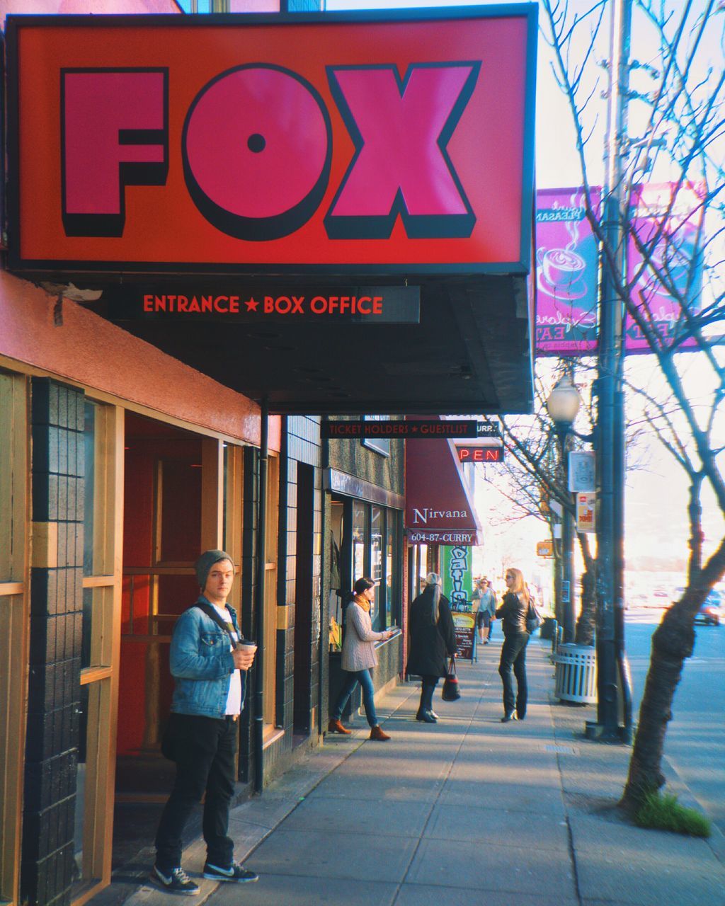 architecture, building exterior, built structure, walking, men, text, street, rear view, person, lifestyles, full length, communication, city, western script, non-western script, city life, leisure activity, sidewalk