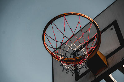 Low angle view of basketball hoop against clear sky