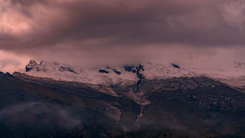 Scenic view of snowcapped mountains against sky during sunset