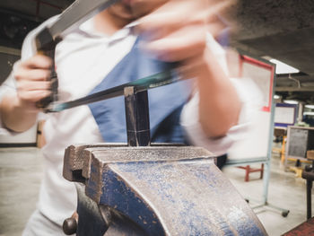 Midsection of man working at workshop