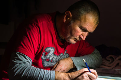 Midsection of man sitting at home
