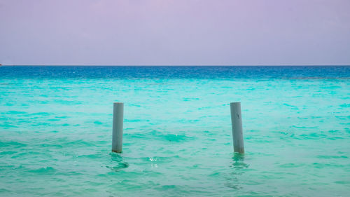 Swimming pool by sea against sky