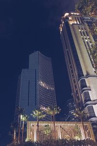 Low angle view of illuminated skyscraper against sky at night