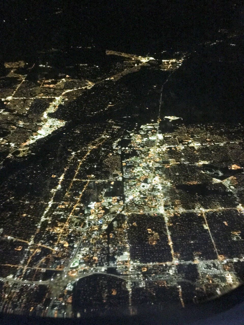 AERIAL VIEW OF ILLUMINATED CITY STREET DURING WINTER