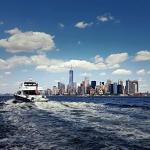 View of sea and cityscape against sky