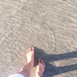 Low section of man wading in sea