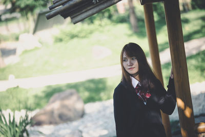 Portrait of beautiful young woman standing outdoors