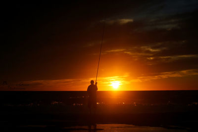 Scenic view of sea against orange sky