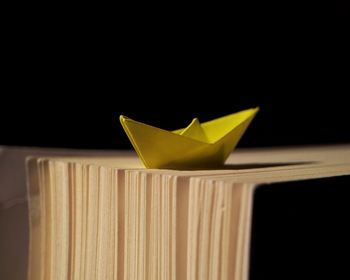 Close-up of yellow paper against black background