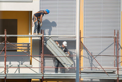 Side view of people working at construction site