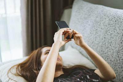 Midsection of woman using mobile phone