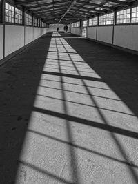 Shadow of people on footpath in building