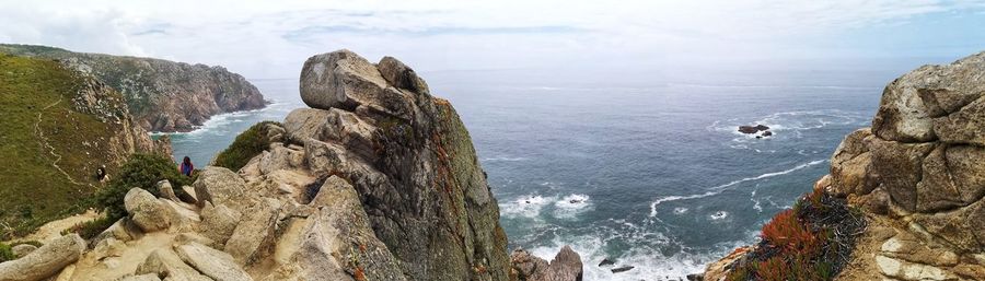 Panoramic view of rocks on sea against sky