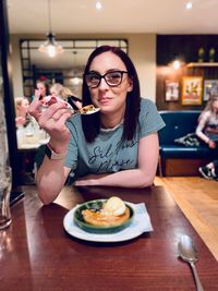 Portrait of woman with food in restaurant