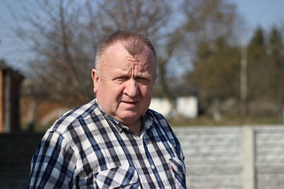 Portrait of senior man standing outdoors