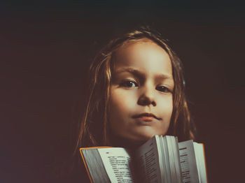 Portrait of girl holding book