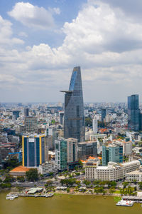 Buildings in city against cloudy sky