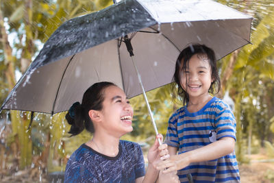 Portrait of a smiling young woman in rain