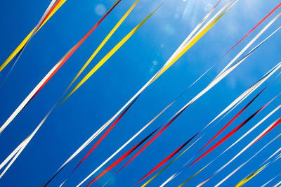 Low angle view of ribbon against blue sky