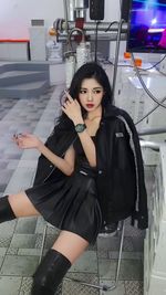 Low angle view of young woman sitting at airport