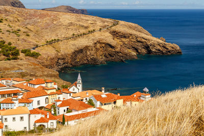 High angle view of houses by sea in town