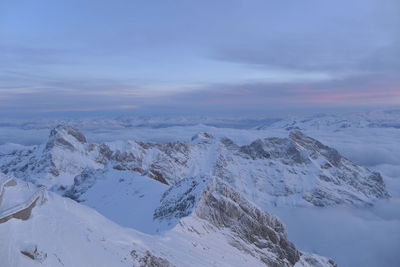 Scenic view of snowcapped mountains against sky during sunset
