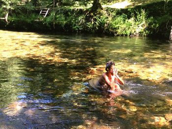 Man swimming in river