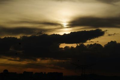 Silhouette trees against sky during sunset