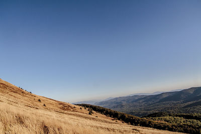 Scenic view of mountains against clear blue sky