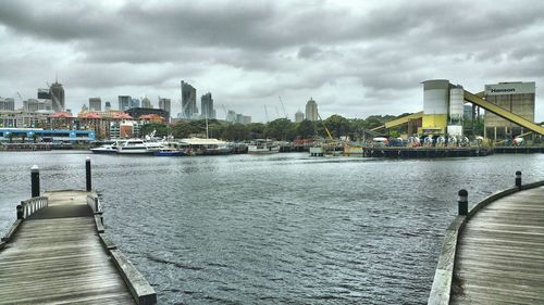 Boats in river with buildings in background