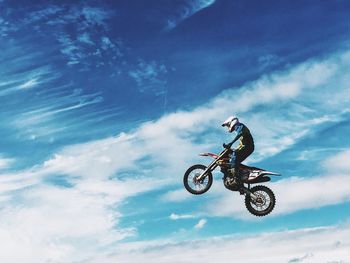 Low angle view of man cycling