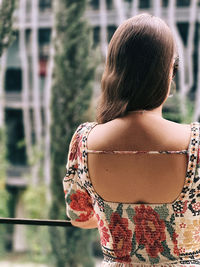 Rear view of young woman standing outdoors