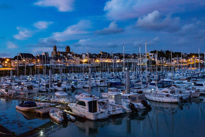 Boats moored at harbor